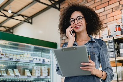 Person with a clipboard on the phone