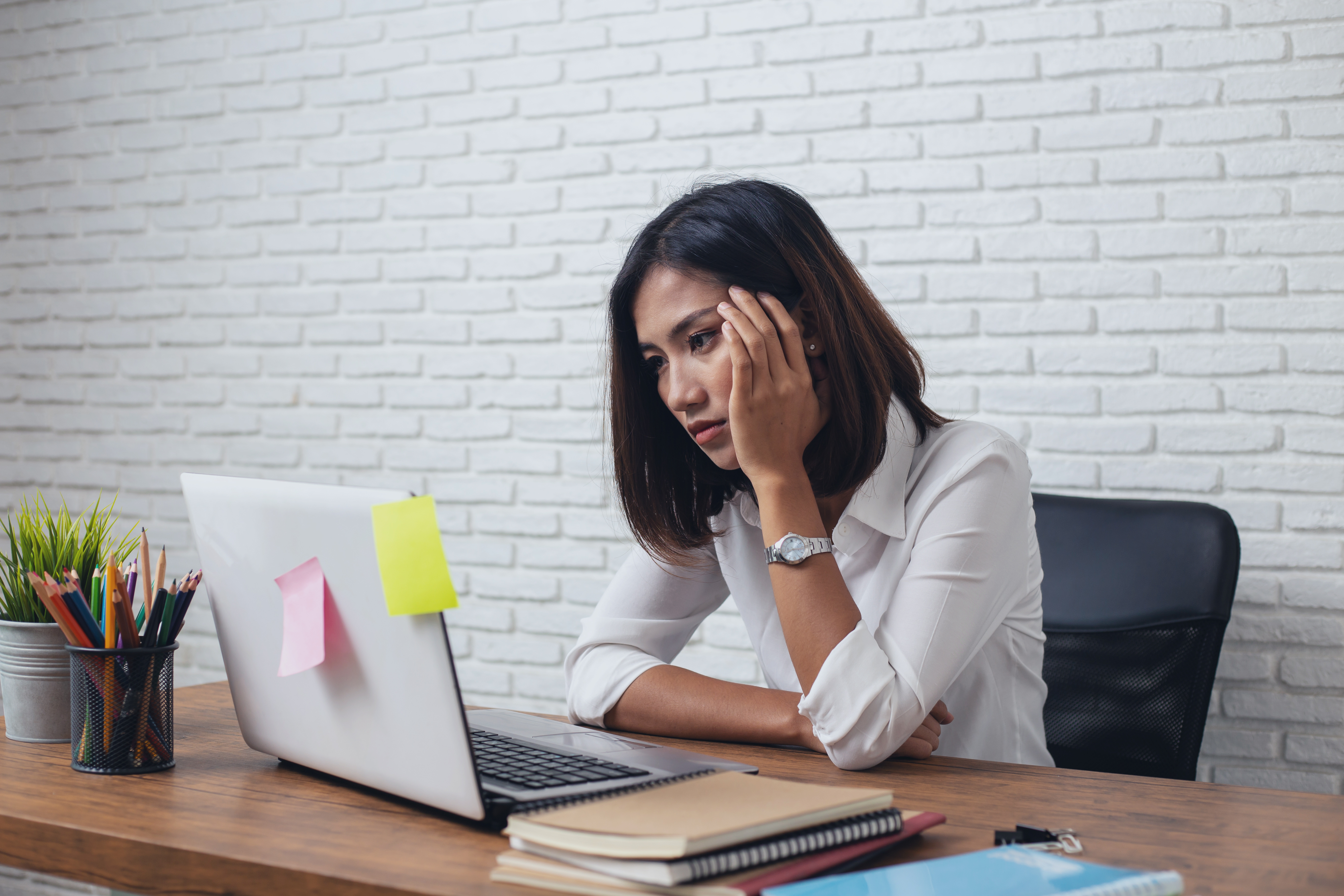 unimpressed woman looking at a laptop screen