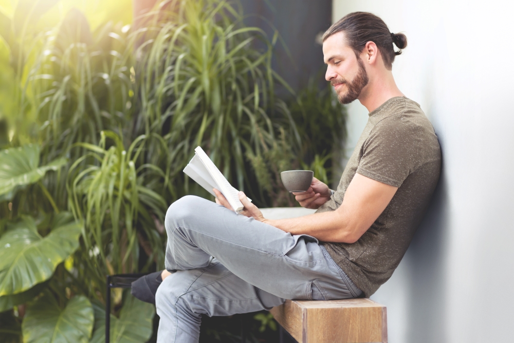 Relaxing Hipster man reading a book.