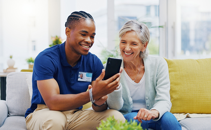 An employee assists a resident at a skilled nursing and assisted living facility. Covering the various liability exposures such facilities face requires working with a specialized agent or broker to design a program of customized property and casualty insurance.